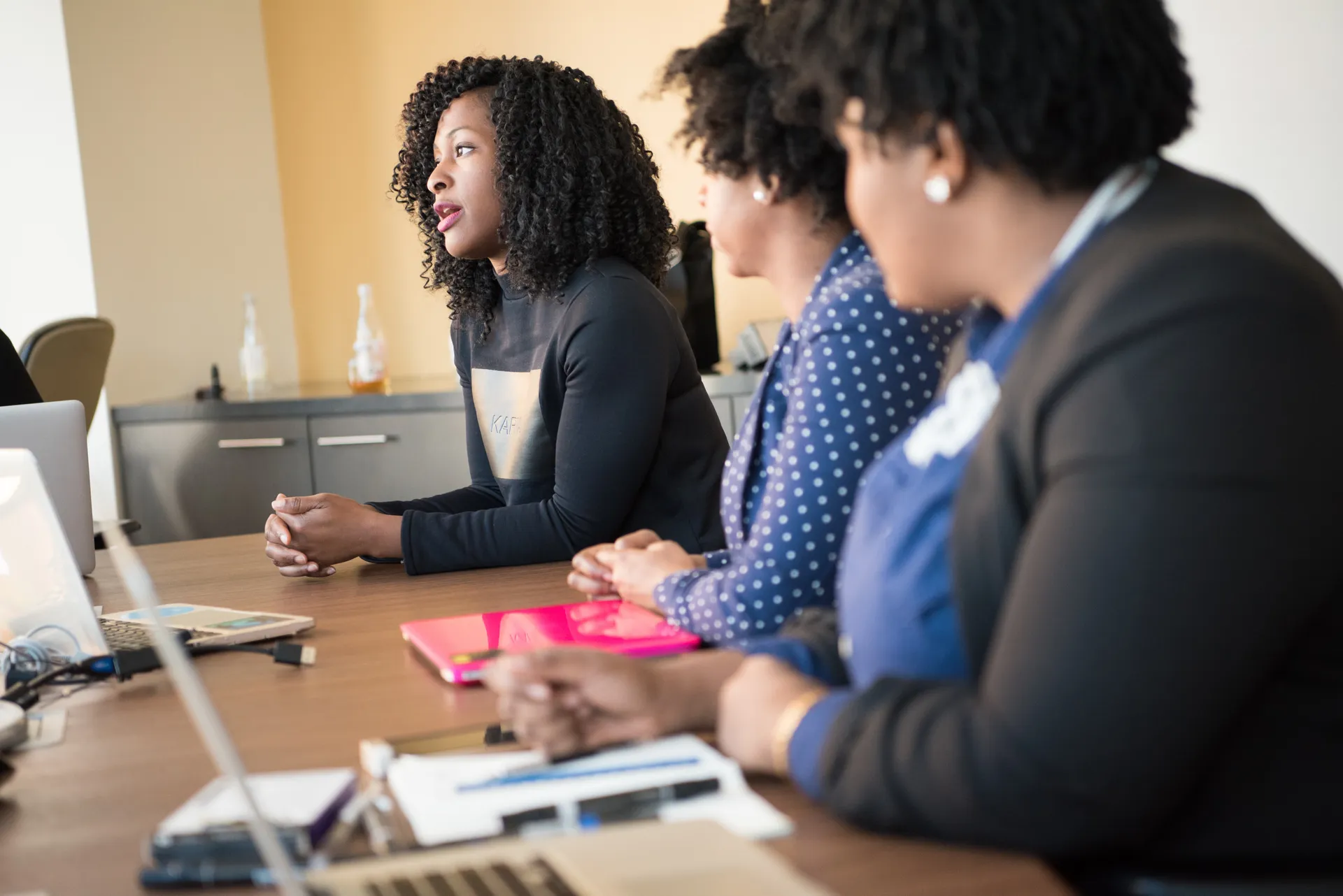 A professional presenting and consulting at a desk in a bright office
